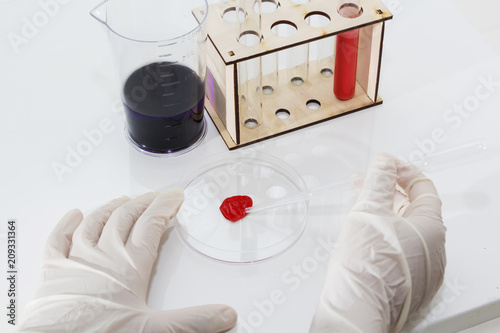 Lab tube, eppendorfs with red liquid. White background. Studio shot. photo