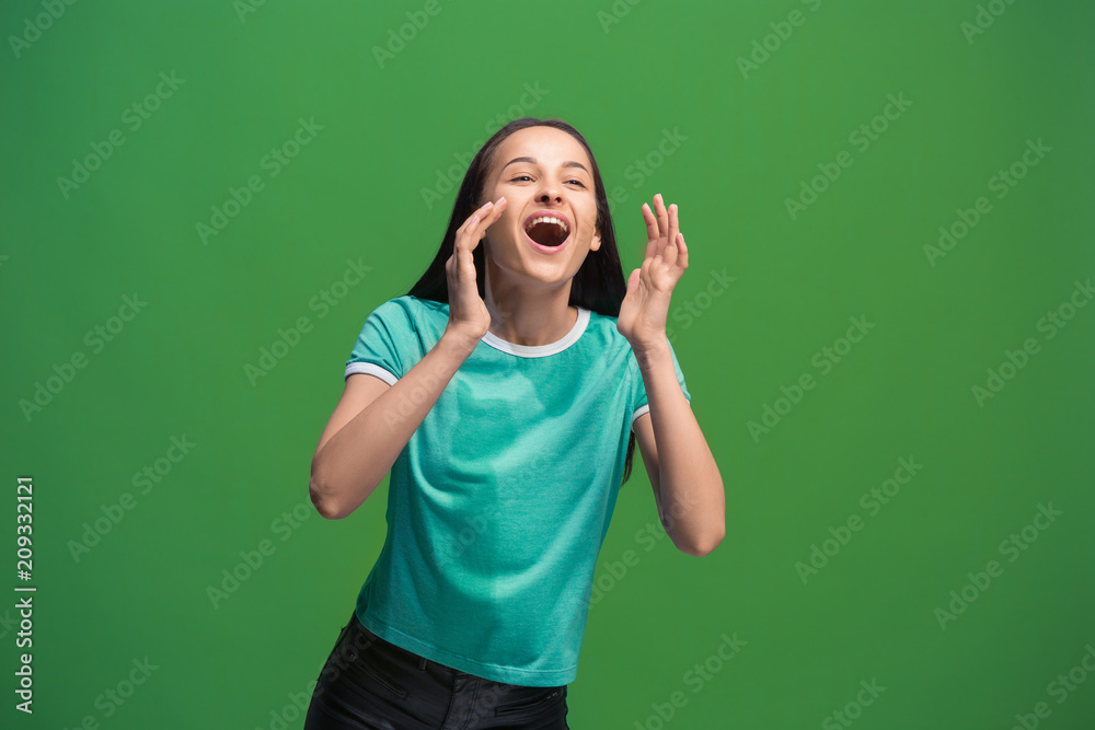 Isolated on pink young casual woman shouting at studio
