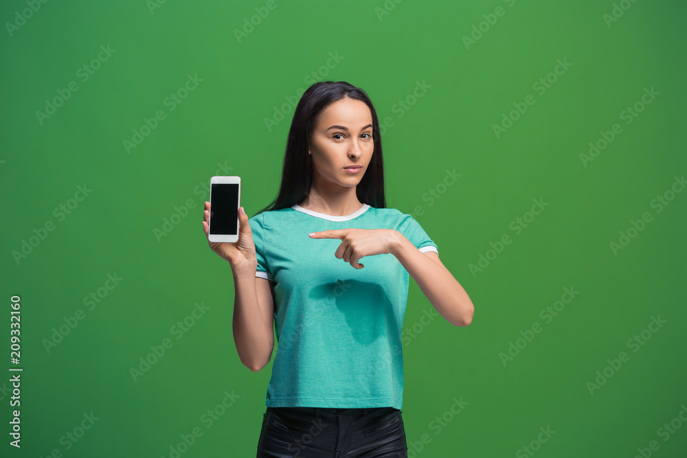 Portrait of a smiling woman showing blank smartphone screen Portrait of a smiling woman showing blank smartphone screen