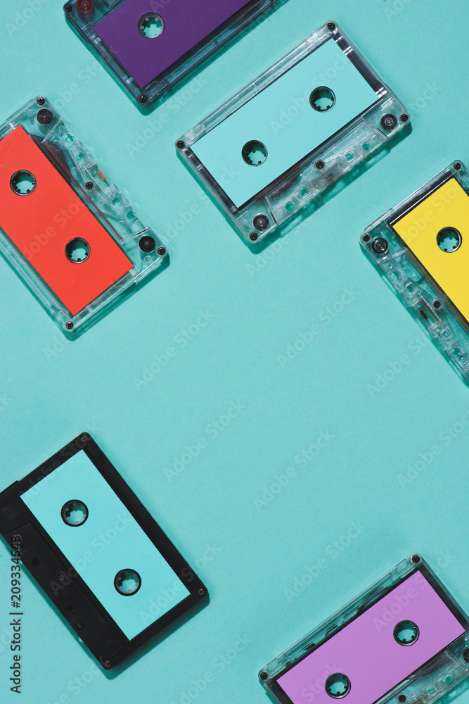 flat lay with arranged colorful retro audio cassettes isolated on blue flat lay with arranged colorful retro audio cassettes isolated on blue