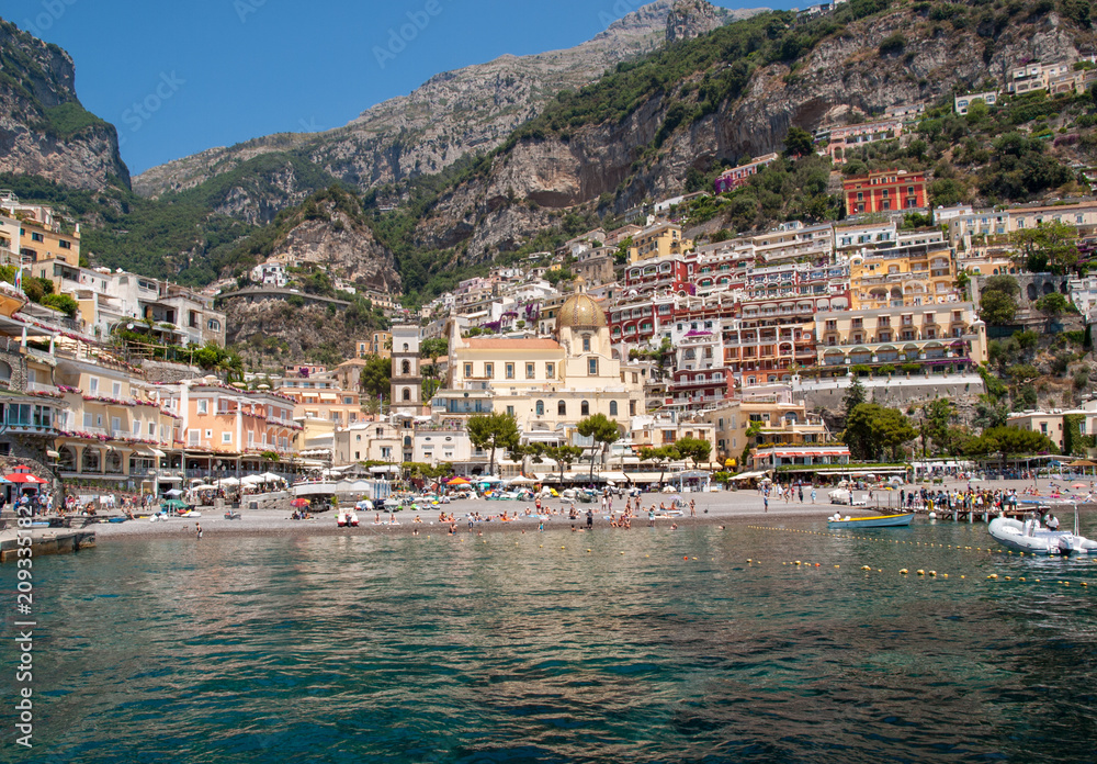 People are resting on a sunny day at the beach in Positano on Amalfi Coast in the region Campania, Italy