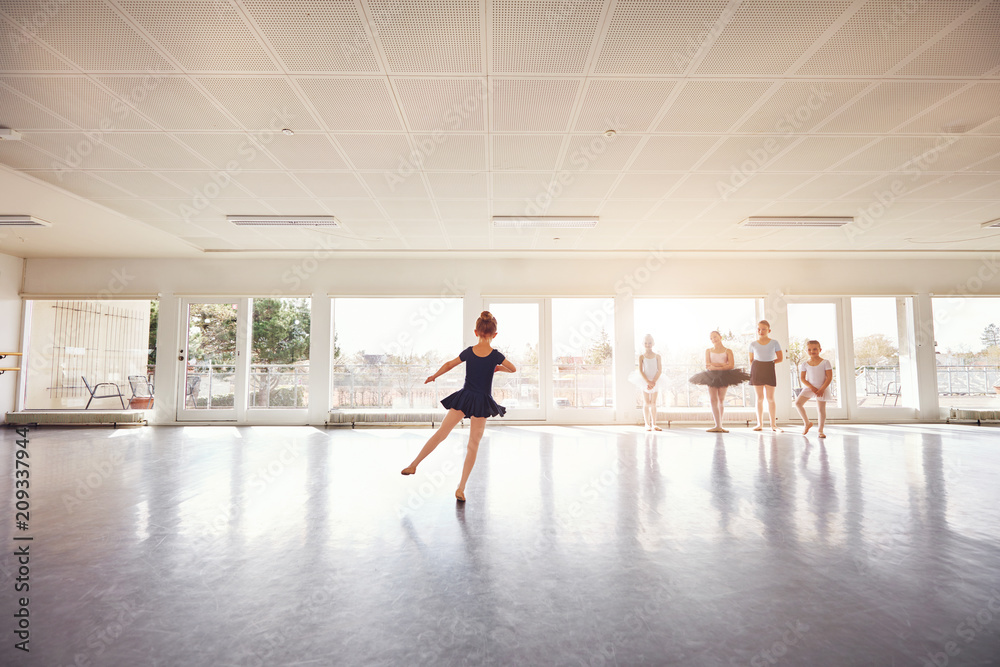 Little girl dancing ballet while group watching Little girl dancing ballet while group watching
