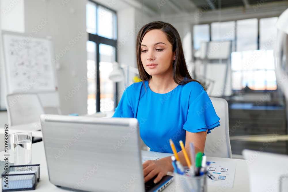 business, technology and people concept - businesswoman with laptop computer working at office business, technology and people concept - businesswoman with laptop computer working at office