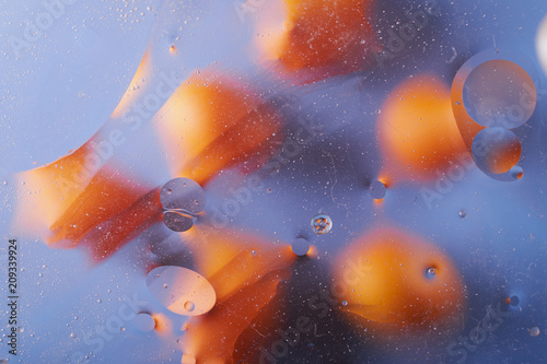 the texture of the background of the oil stains on the water circles yellow blue abstraction