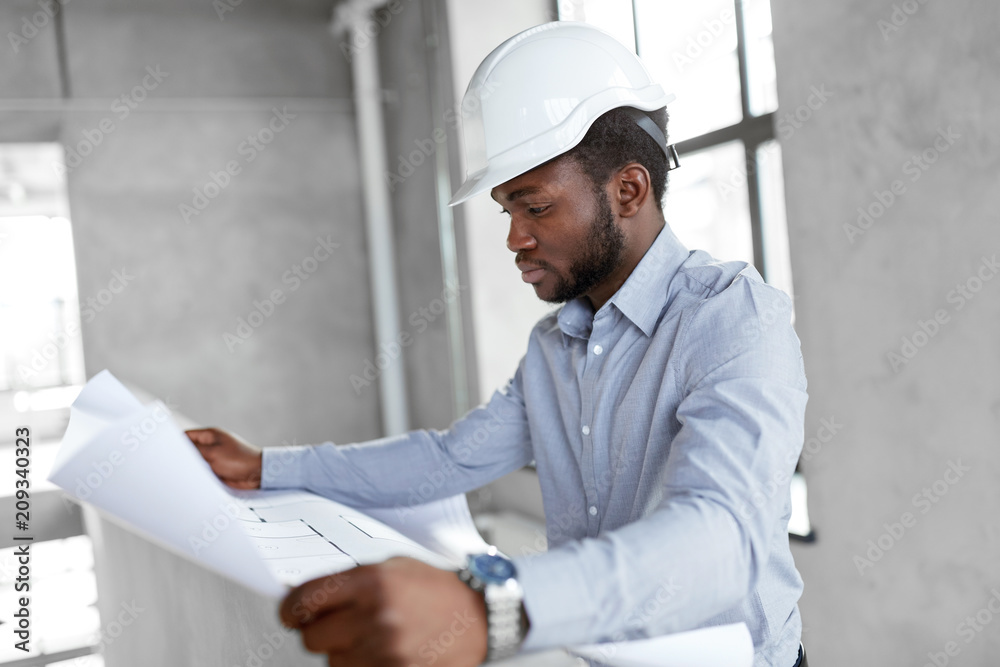 architecture, construction business and people concept - african american architect in helmet with blueprint architecture, construction business and people concept - african american architect in helmet with blueprint