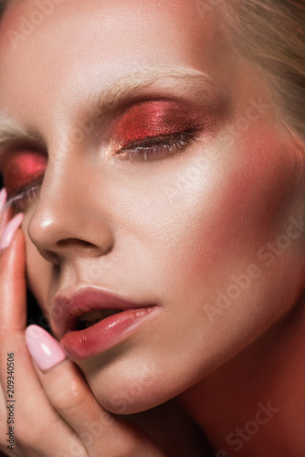 close up of attractive girl with closed eyes and red makeup for fashion shoot