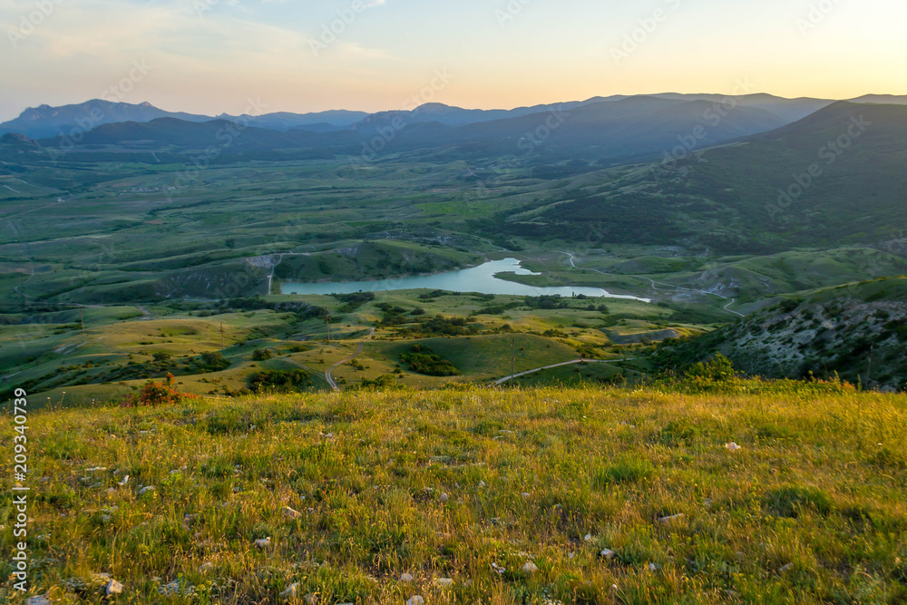 Naklejka premium Green meadows and mountains