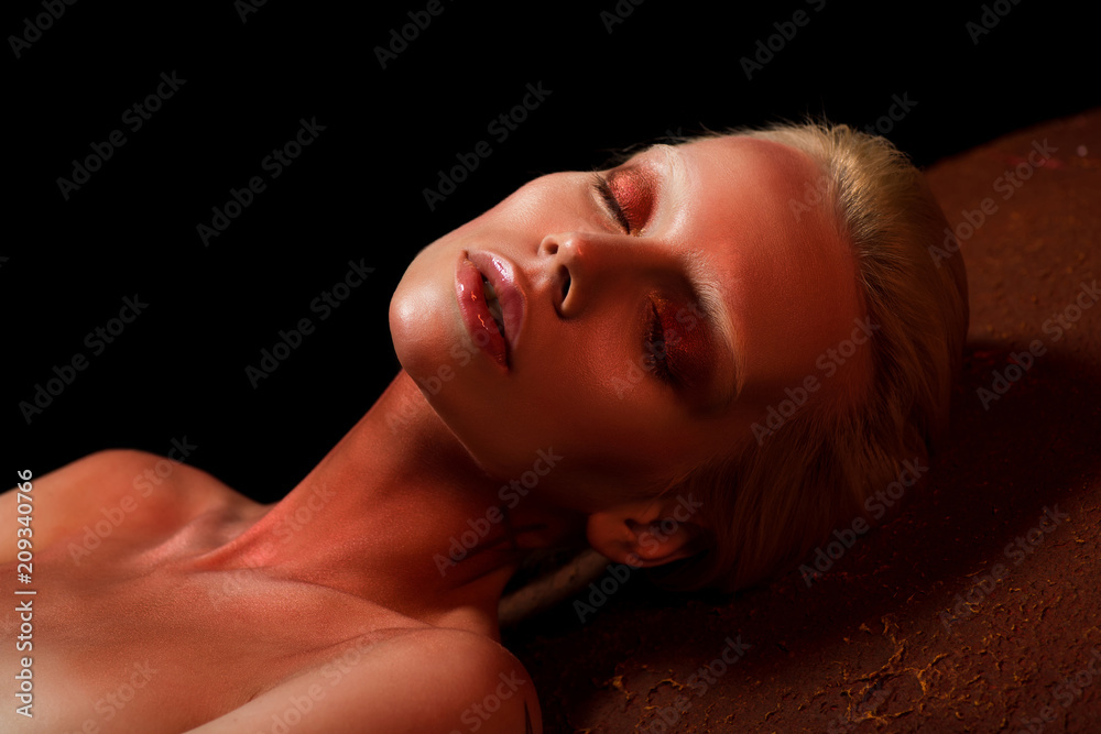 attractive woman with closed eyes and red body art posing for fashion shoot on black attractive woman with closed eyes and red body art posing for fashion shoot on black