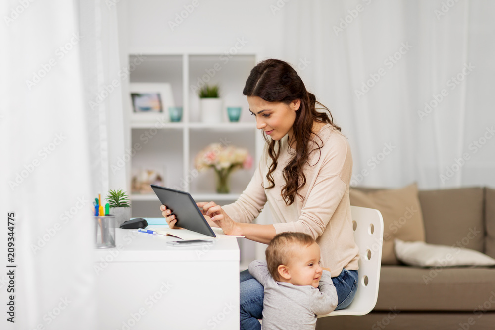 multi-tasking, education, motherhood and technology concept - happy mother student with baby and tablet pc computer learning at home multi-tasking, education, motherhood and technology concept - happy mother student with baby and tablet pc computer learning at home