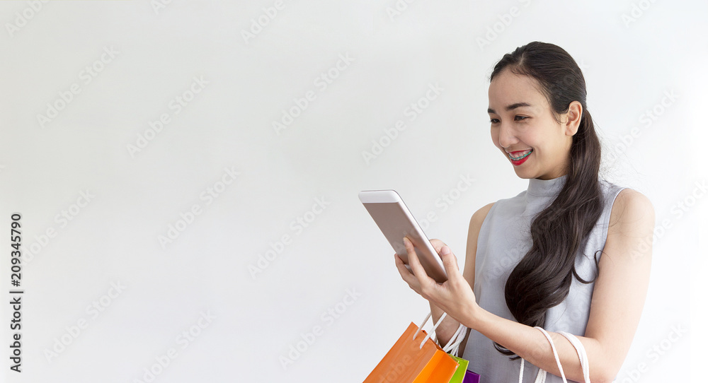 Lady buying online with tablet. Happy woman paying in coffee shop by smartphone. Woman took a contactless payment. Lady buying online with tablet. Happy woman paying in coffee shop by smartphone. Woman took a contactless payment.
