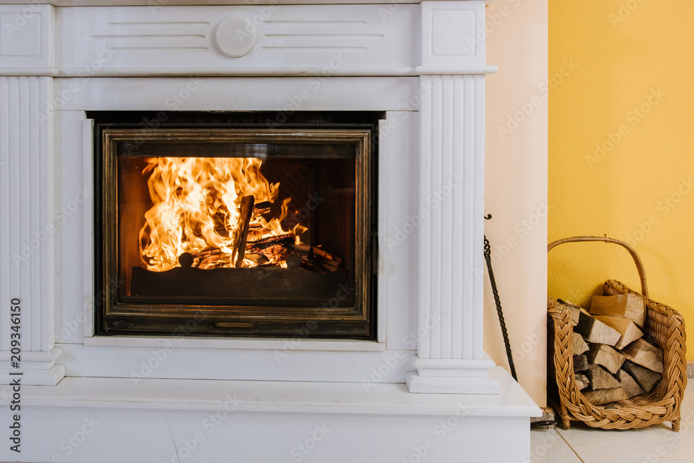 A fireplace in house an a firewood near by A fireplace in house an a firewood near by
