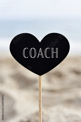 heart-shaped signboard with text coach photo