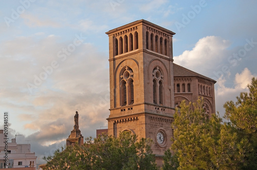 Church with tower and Holy Mary statue