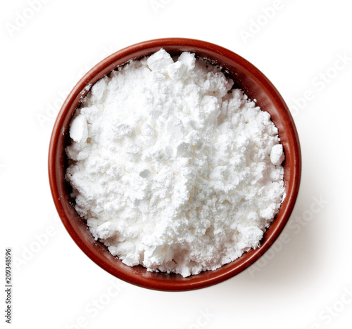 Foto Bowl of powder sugar on white background, from above