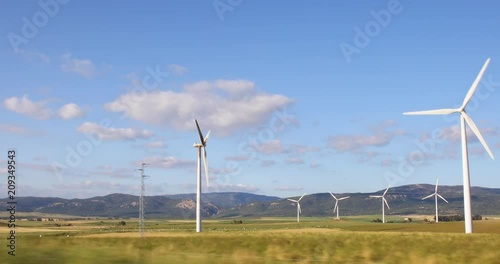 Shot from car: spoiled wind renewable power turbine, in a group, in landscape of Cadiz, Andalusia, Spain, Europe
 photo
