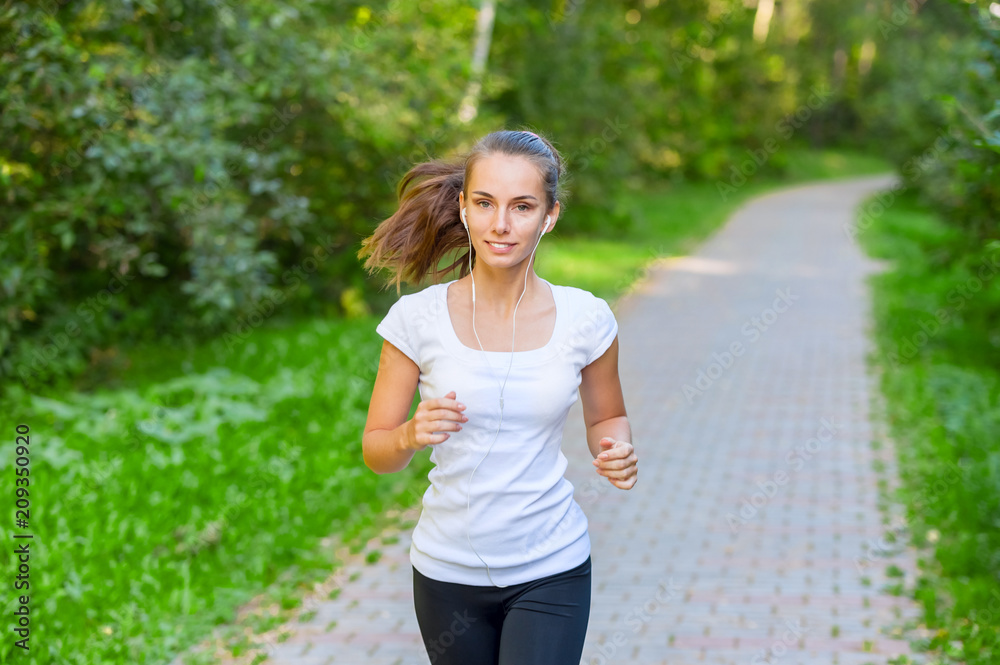 Running girl atletic spotsman trains in the summer park. Outdoor fitness portrait Running girl atletic spotsman trains in the summer park. Outdoor fitness portrait