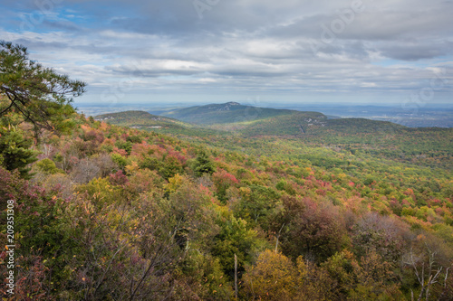Overlooking the Shawangunk Mountain Range surrounded by bright fall foliage on a partly cloudy afternoon at Minnewaska State Park, Kerhonksen, NY