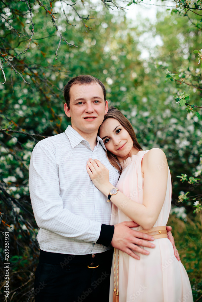 a young couple in love in the spring flowering Park