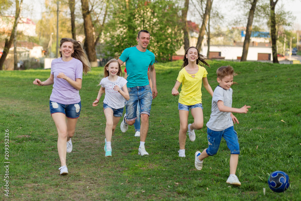 Family playing football on the field. Family football