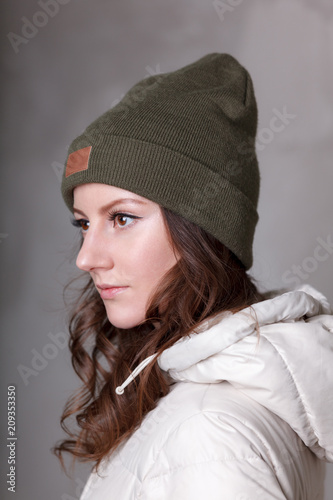 Girl in fashionable pose. Green khakhi winter clothing. Trendy style.