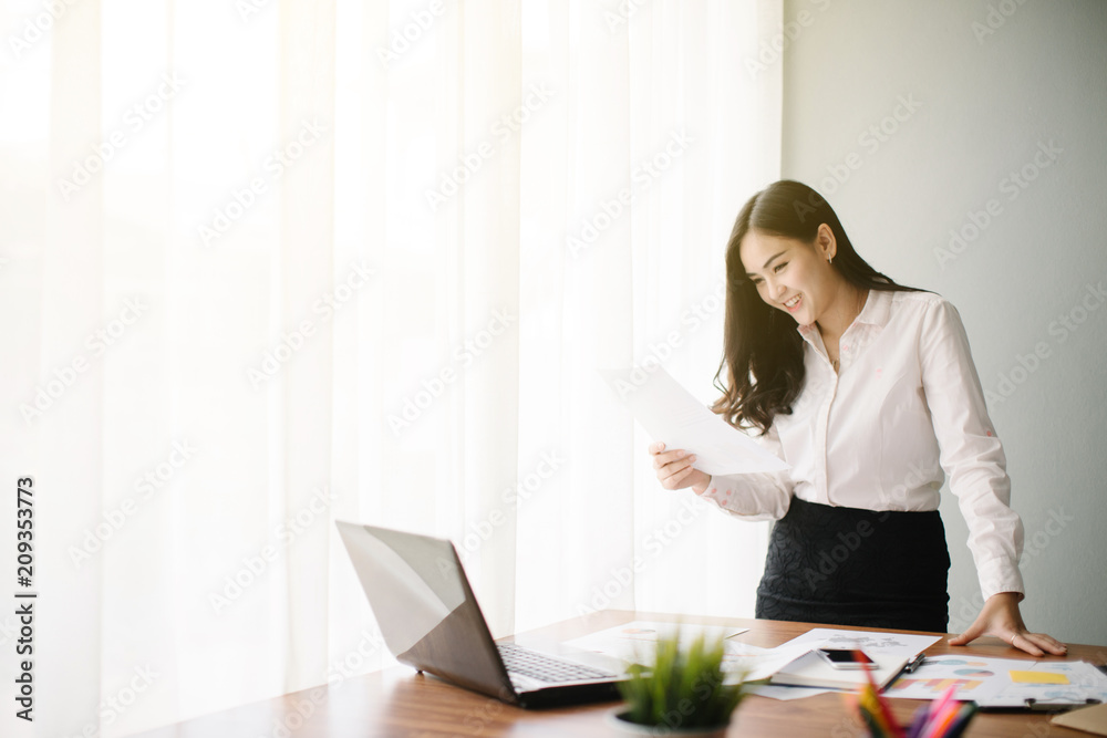 Fototapeta premium Beautiful young Asia woman working in office