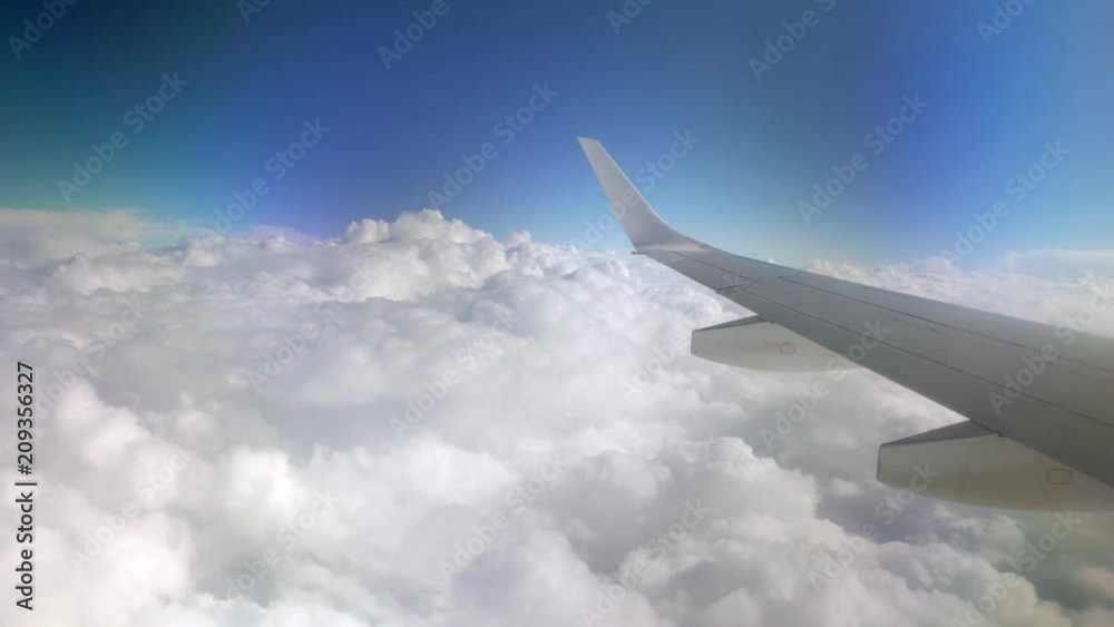 plane flying between clouds
plane flying between clouds