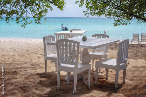 Cafe tables on a sandy beach by the sea