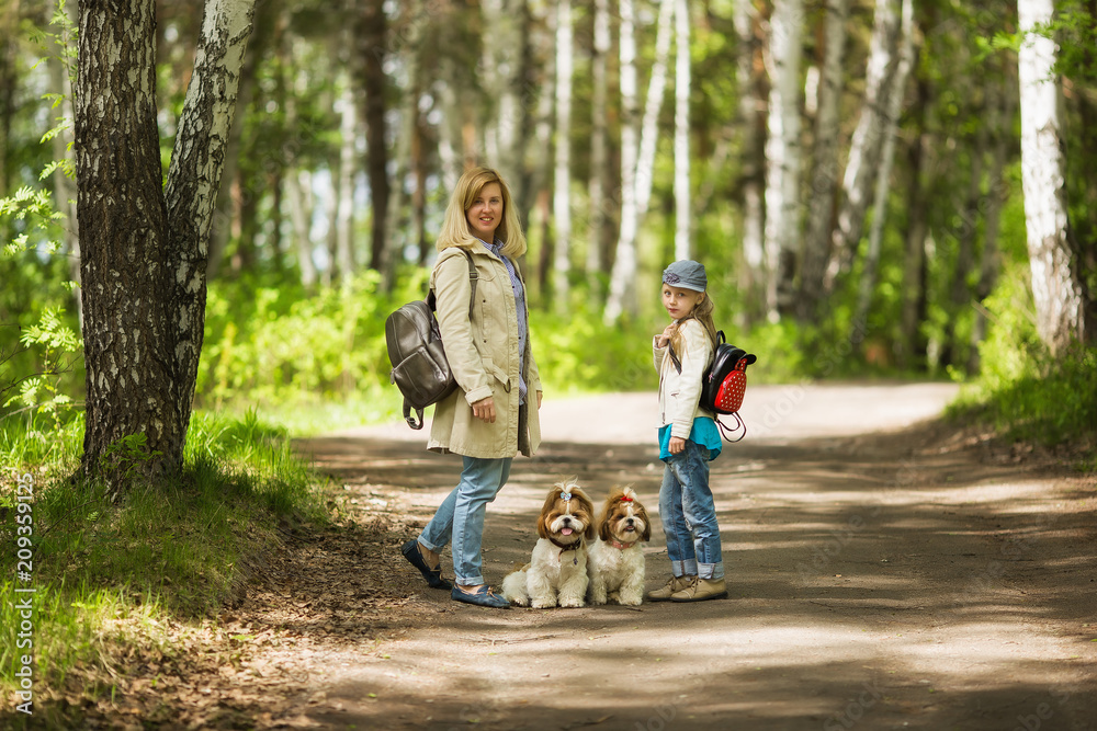 Mother and Daughter Walking the Dogs