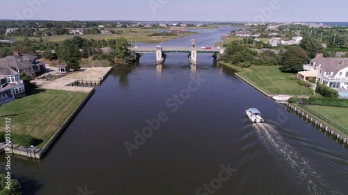 Aerial Houses in the Hamptons with Private Docks and a Boat on the Bay photo