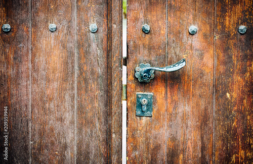 Wooden gate with door knob and keyhole.