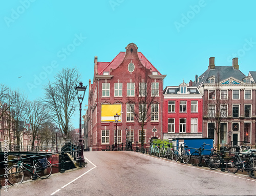 Empty streets of Amsterdam. Quarantine. Coronavirus concept. Traditional dutch old houses and bridges on canals in Amsterdam, Netherlands © domarevatanya