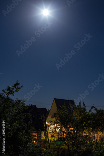 country house in deep night in full moon illumination