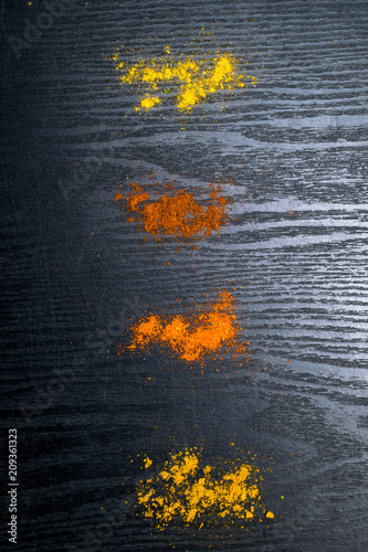 spill colorful spices on wooden background photo