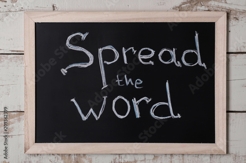 Text "Spread the word" on framed blackboard. Online announcement. Information sharing