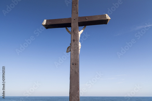  Cross with sculpture Christ crucified,mediterranean sea in maritime village of Colliuore, sotuh France.