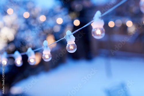 String of glowing party lights outdoors in winter