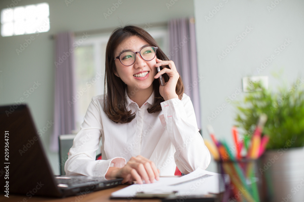business concept - businesswoman talking on the phone in office business concept - businesswoman talking on the phone in office