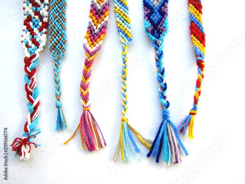 friendship bracelets made of thread with braids on white background
