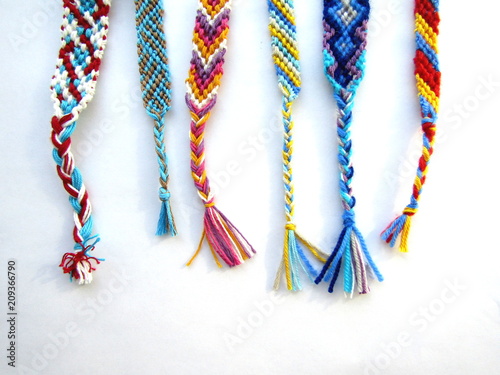 friendship bracelets made of thread with braids on white background