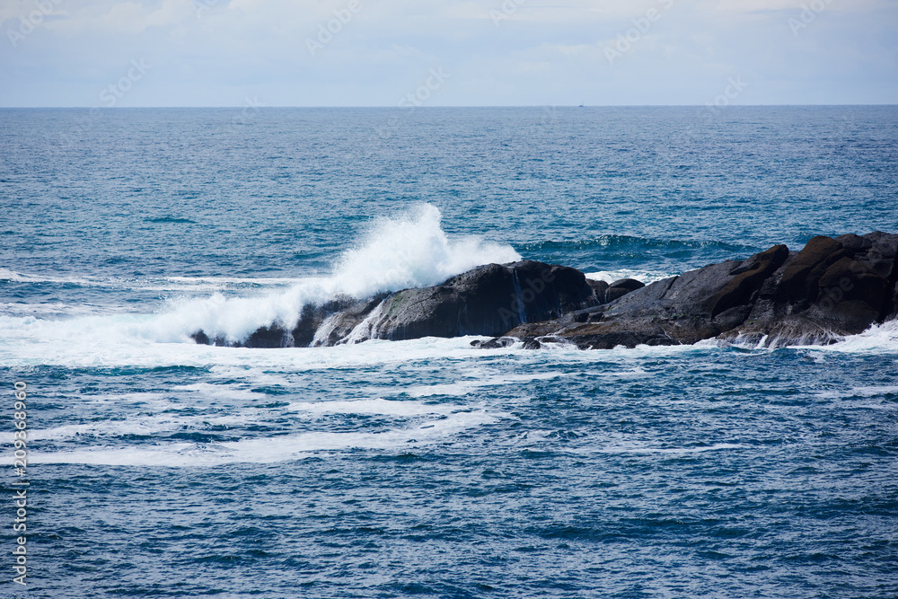 Waves break over an offshore rock in Depoe Bay, Oregon