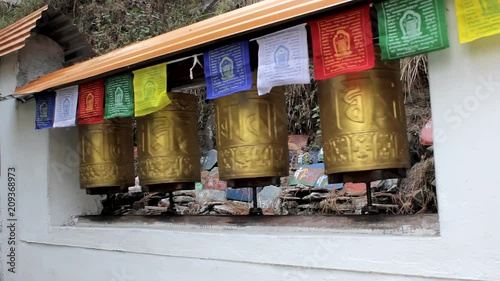 Dharamshala, Mcleodganj, Himachal Pradeh/ India - 10.06.2018: Near Dalai lama temple. Spinning Tibetan drums with mantras photo