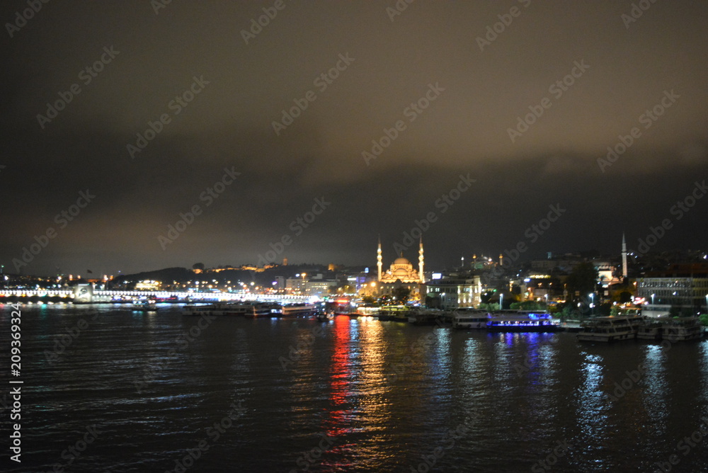  sea strait with beautiful luminous boats, a bridge, a mosque with illumination and buildings
