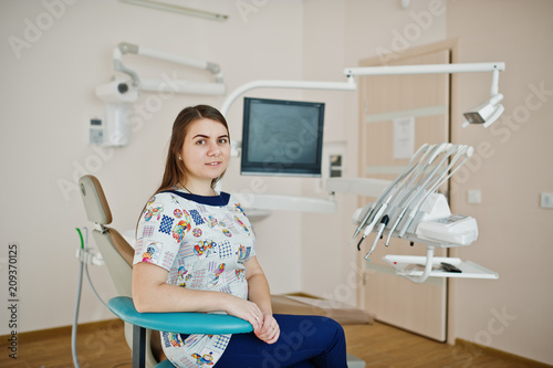Portrait of baby dentist female at her dental office.