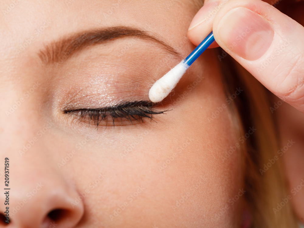 Woman getting her makeup done with cotton buds