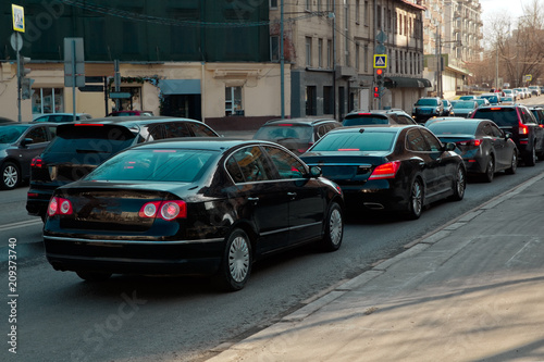 Narrow city oad with cars in traffic jam. Red traffic light. © Slava
