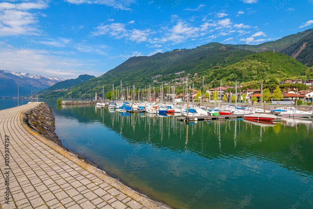 Port of Gera Lario with moored boats in sunny summer day. Lombardia, Italy