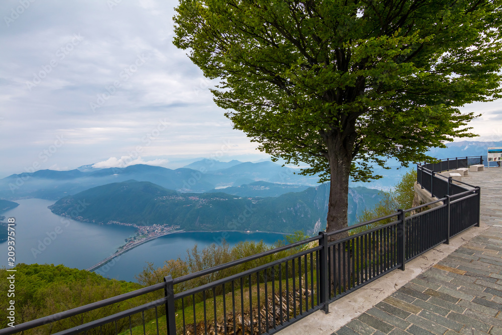Balcony of Italy - Panorama of Lake Lugano in cloudy day. Alps with Mount blanc in background. Lombardia, Italy