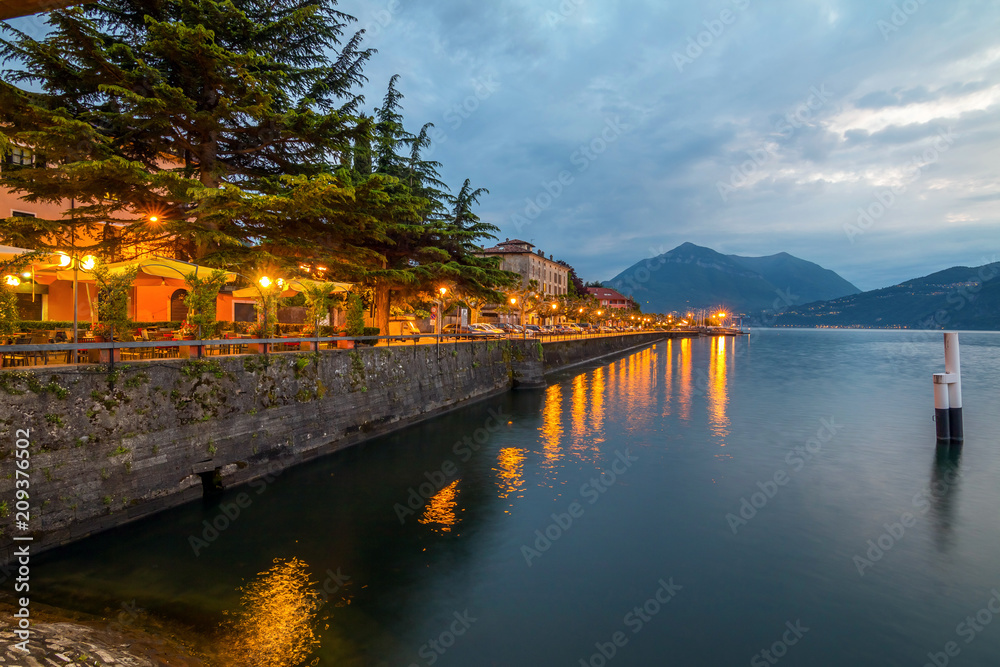 holidays in Italy - a view of a city Bellano, with the most  beautiful lake in Italy - Lago di Como in background. Area of famous Belano City at sunset