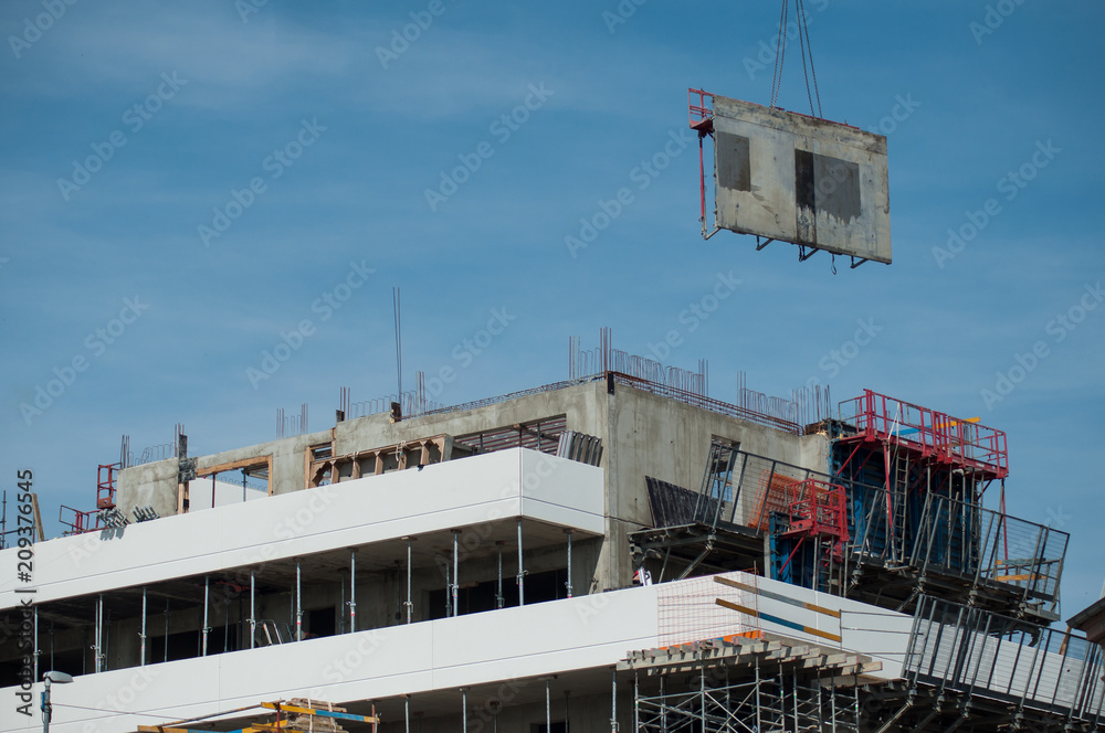 Naklejka premium crane removing formwork elements on a building under construction
