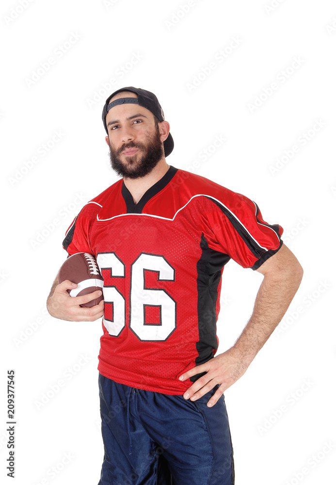 Young football player standing in closeup with his football Young football player standing in closeup with his football